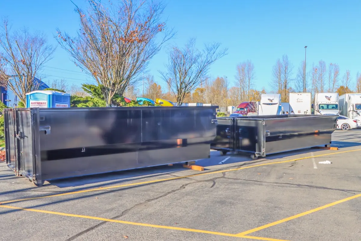 Professional dumpster rental service with roll-off container on residential driveway in Ranchettes